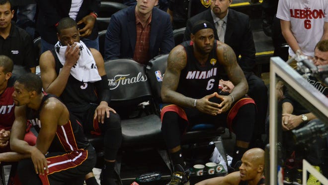 Miami Heat forward LeBron James (6) sits on the bench at the end of the game against the San Antonio Spurs in Game of the 2014 NBA Finals at AT&T Center on June 15, 2014.