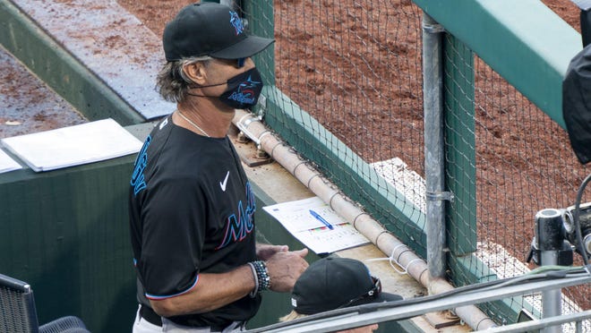 Miami Marlins' manager Don Mattingly looks out from the dugout during the eighth inning of a baseball game against the Philadelphia Phillies, Saturday, July 25, 2020, in Philadelphia.
