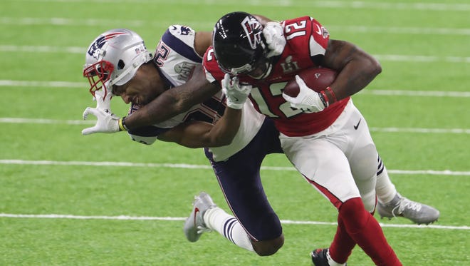 Atlanta Falcons wide receiver Mohamed Sanu (12) is tackled by New England Patriots cornerback Logan Ryan (26) in the fourth quarter during Super Bowl LI at NRG Stadium.