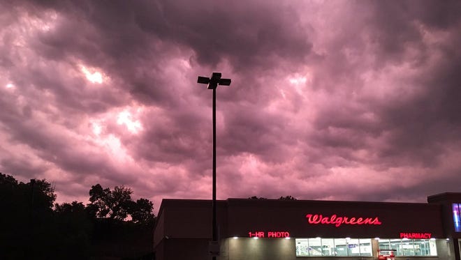 Storms roll through the skies over over East Mitchell Avenue and Vine Street Sunday evening.