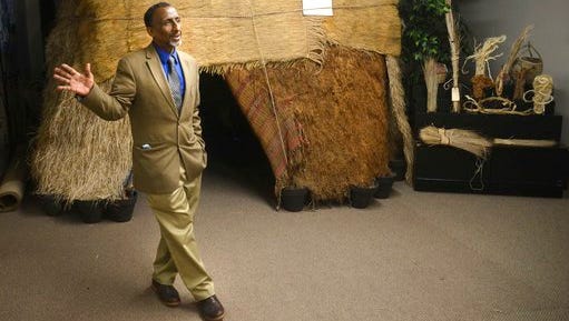 This photo taken April 14 shows Osman Mohamed Ali standing in front of a traditional nomad Somali hut and homestead at the Somali Museum of Minnesota in Minneapolis.
