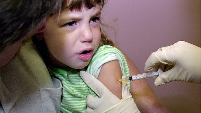 Hayley Van Dusen of Florence, Kentucky gets a measles and mumps immunization shot at Boone County Health Clinic in Florence in 2012.