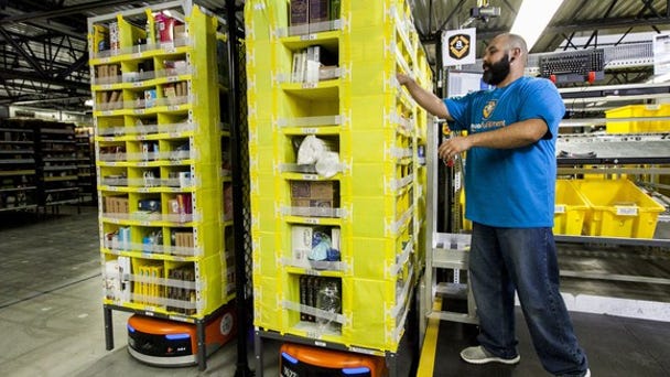 Amazon worker picking items in a fulfillment...