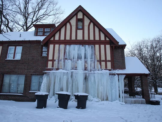 E. T. Williamson’s home at West Boston and 14th Street in Detroit sits damaged after a water pipe burst, causing water to freeze inside and outside the home.
