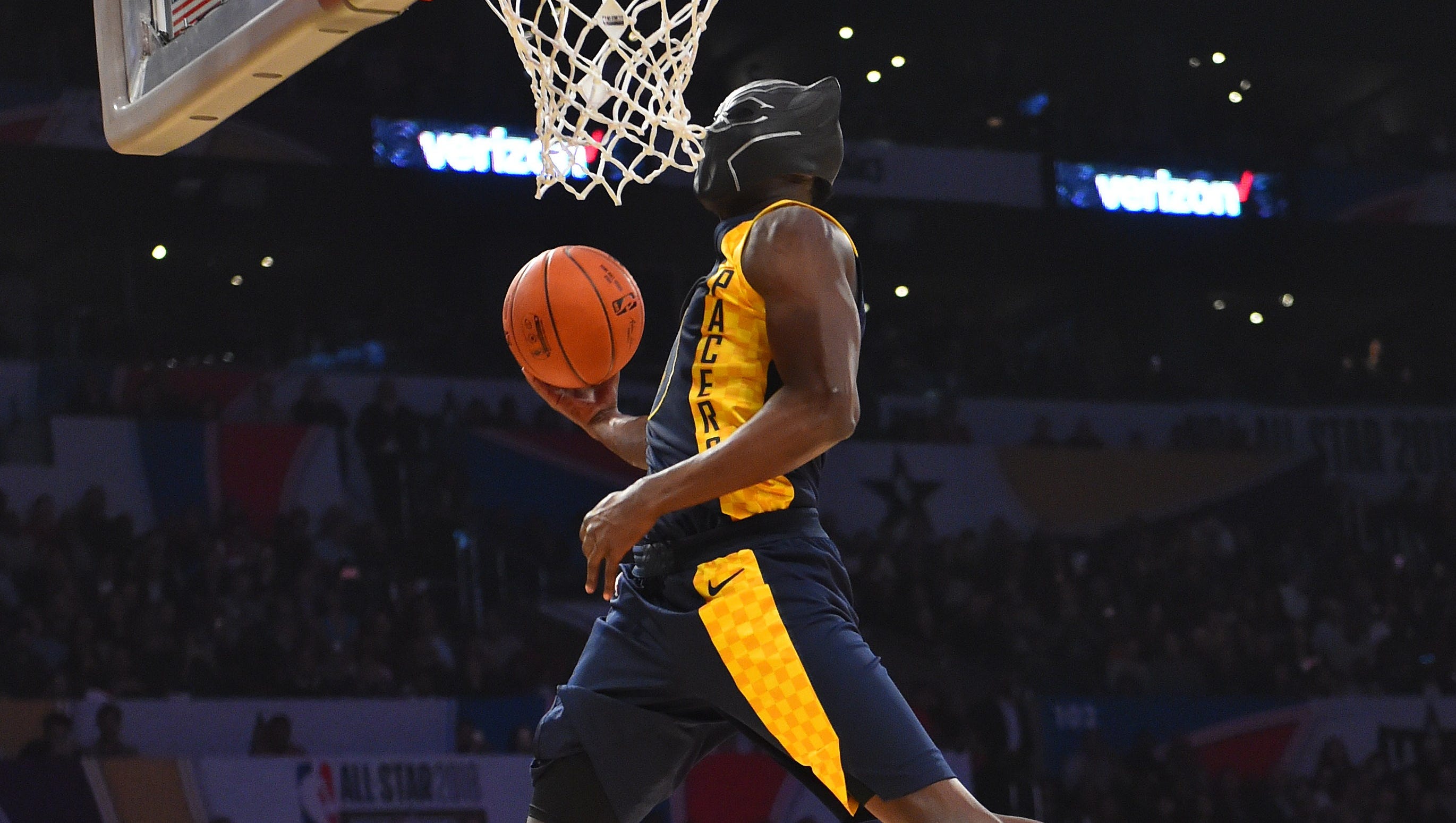 Pacers star Victor Oladipo pictured dunking while wearing a Black Panther superhero mask.
