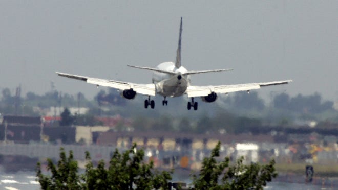 A passenger jet lands at Newark Liberty International Airport.