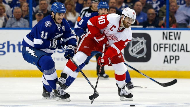 The Lightning's Brian Boyle checks Red Wings forward Henrik Zetterberg during the second period of Game 2 Friday in Tampa.