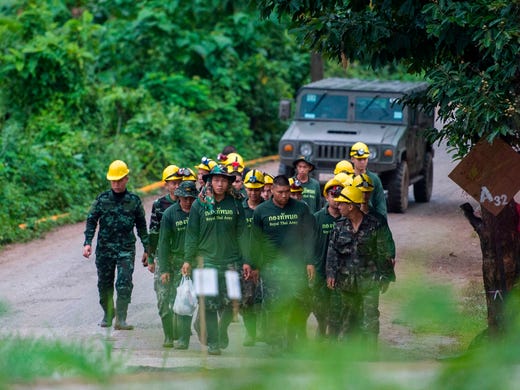 Thai soldiers walk out from the Tham Luang cave area