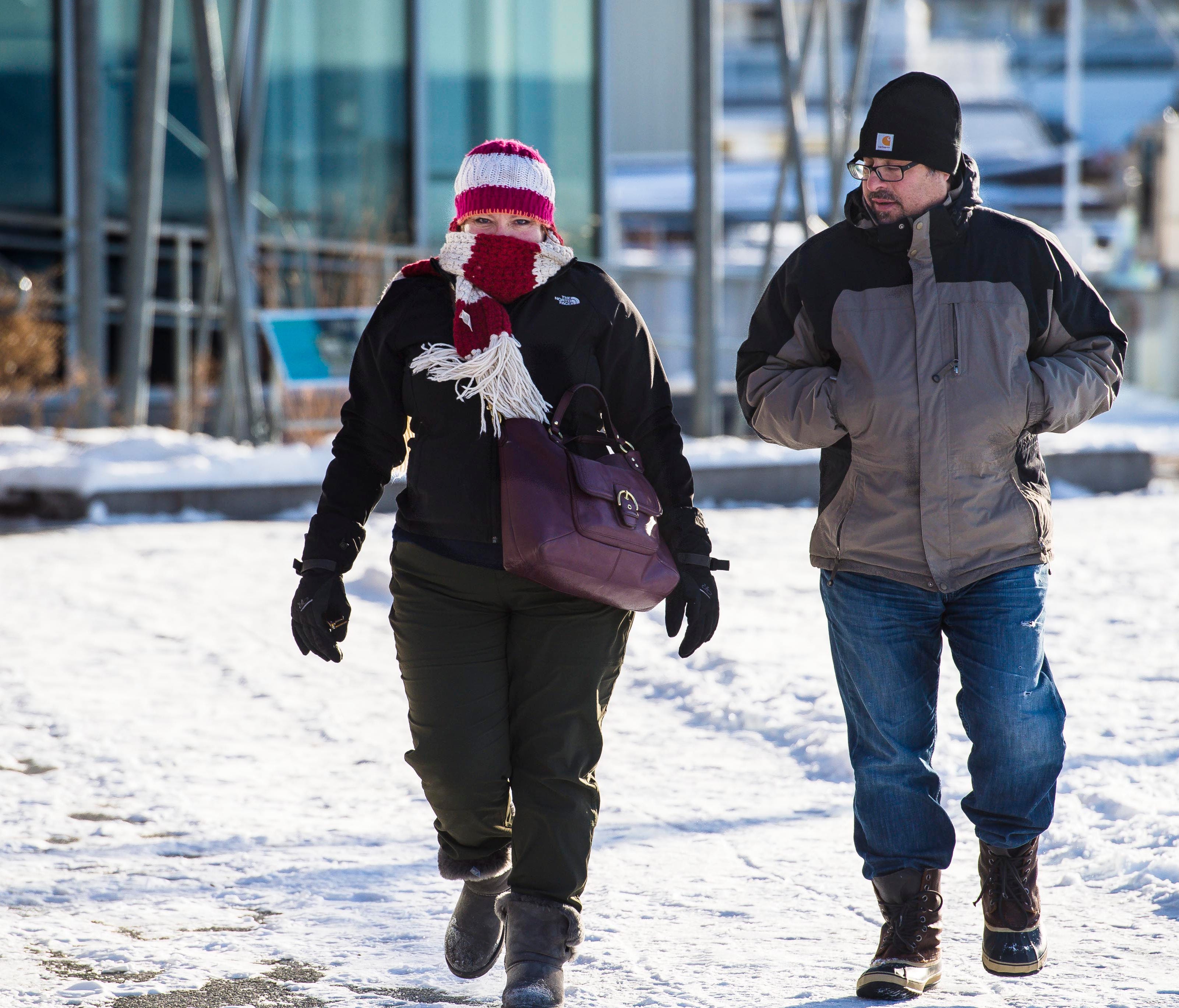 Pedestrains brave cold weather for a stroll along Lake Champlain at Waterfront Park in Burlington on Wednesday, December 27, 2017.
