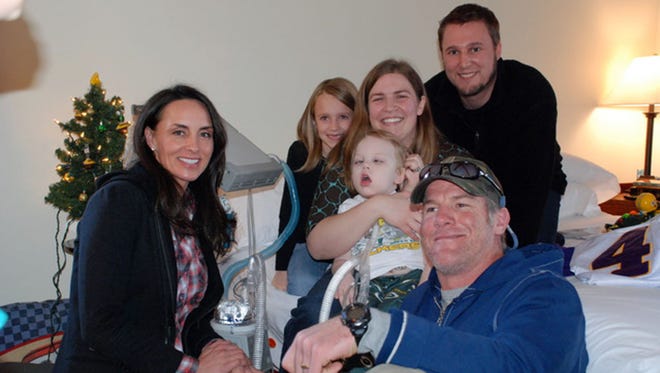 Brett and Deanna Favre pose with the Butzine family. The family (from left) is Ella, Jon, Michelle and Anderson.