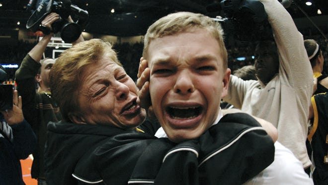 Debbie McElwain hugs and kisses her son Jason, as they realized Greece Athena won the 2006 Section V Class AA championship at the Blue Cross Arena in Rochester.