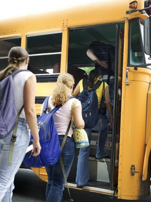 Students getting on school bus