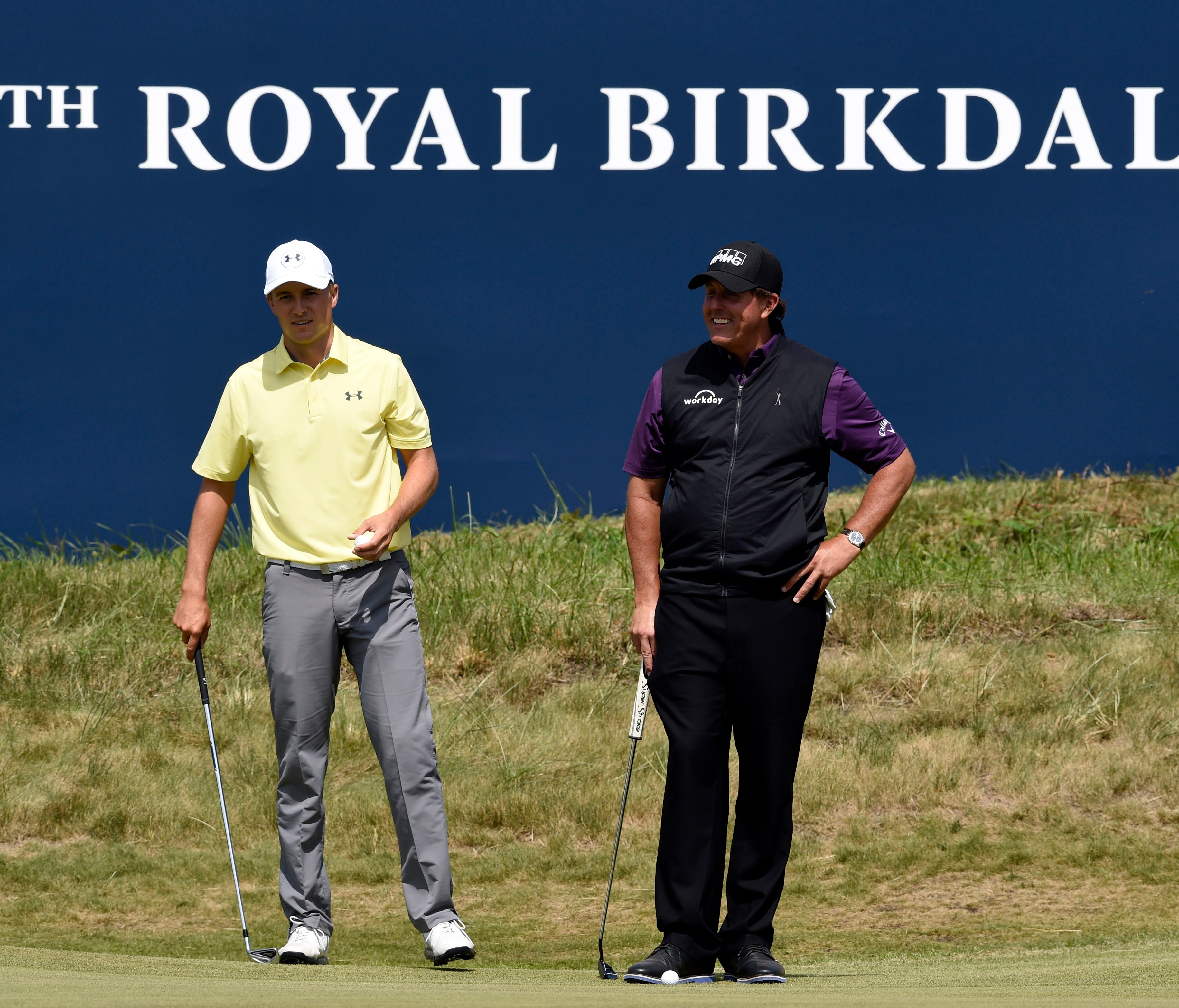 Jordan Spieth (left) and Phil Mickelson on the 18th green during a practice round of The 146th Open Championship golf tournament at Royal Birkdale Golf Club on July 18.