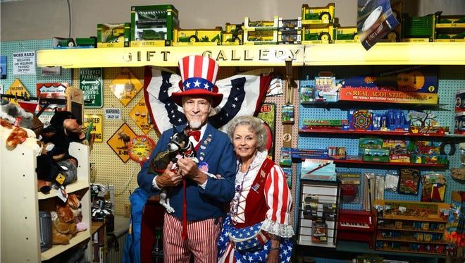 Mr. and Mrs. Uncle Sam, aka Bobbie and Gene Carnell, stand with their dog Scooter at Town Hardware in downtown Black Mountain Friday.