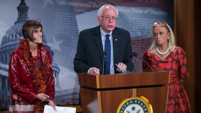 Sen. Bernie Sanders, I-Vt., with Democratic Rep. Rosa DeLauro of Connecticut, left, and Democratic Rep. Debbie Dingell of Michigan, speaks at a press conference to oppose the Trans-Pacific Partnership in Washington on Sept. 14, 2016.