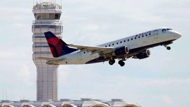 A Delta Air Lines jet takes off July 28, 2014, from Ronald Reagan Washington National Airport in Arlington, Va.