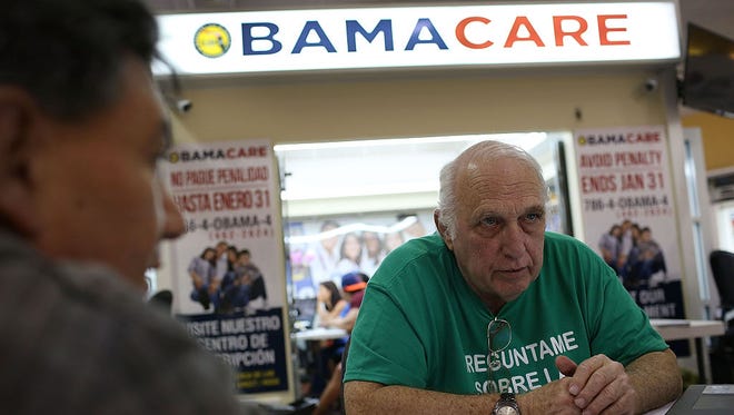 MIAMI, FL - NOVEMBER 02: Antonio Galis, an insurance agent from Sunshine Life and Health Advisors, discusses with a client plans available in the third year of the Affordable Care Act at a store setup in the Mall of the Americas on November 2, 2015 in Miami, Florida. Open Enrollment began yesterday for people to sign up for a 2016 insurance plan through the Affordable Care Act.  (Photo by Joe Raedle/Getty Images)