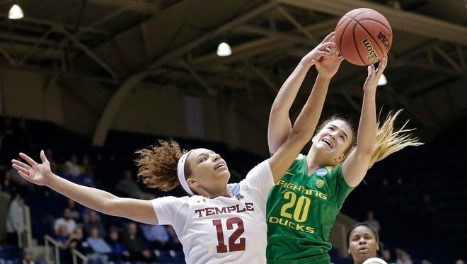 Temple's Ruth Sherrill (12) and Oregon's Sabrina Ionescu (20) reach for a rebound during the first half of a first-round game in the NCAA women's college basketball tournament in Durham, N.C., Saturday, March 18, 2017. (AP Photo/Gerry Broome)