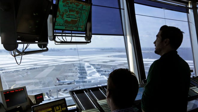 Air traffic controllers work March 16, 2017, in the tower at John F. Kennedy International Airport in New York.