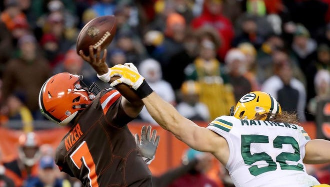Green Bay Packers outside linebacker Clay Matthews (52) hits Cleveland Browns quarterback DeShone Kizer (7) forcing a bad throw which was intercepted in overtime on Dec. 10, 2017 at FirstEnergy Stadium in Cleveland.
