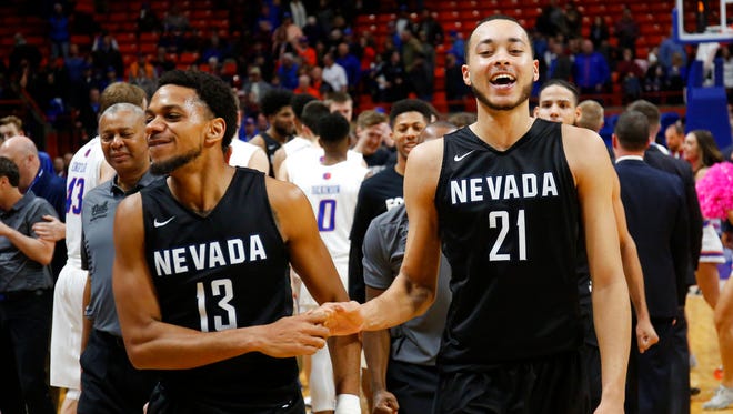 Nevada's Hallice Cooke (13) and Kendall Stephens (21) celebrate the team's 77-72 win over Boise State in an NCAA college basketball game in Boise, Idaho, Wednesday, Feb. 14, 2018.