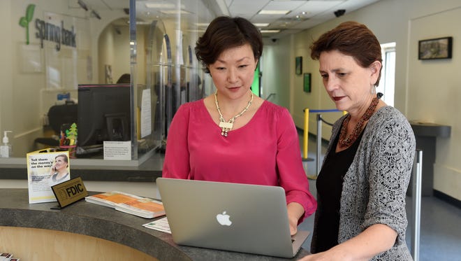 Kate Hao, left, founder of Happy Mango, with Melanie Stern, director of Consumer Lending for Spring Bank, at the Spring Bank branch office in the Bronx. Happy Mango is partnering with Spring Bank in a pilot program for its alternative credit scoring model.