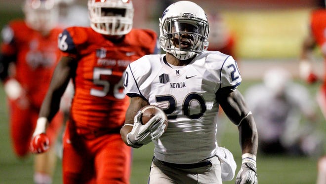 James Butler, one of two Nevada running backs to run for more than 1,000 yards this season, runs away from Fresno State defenders for a touchdown during a Nov. 5 game.