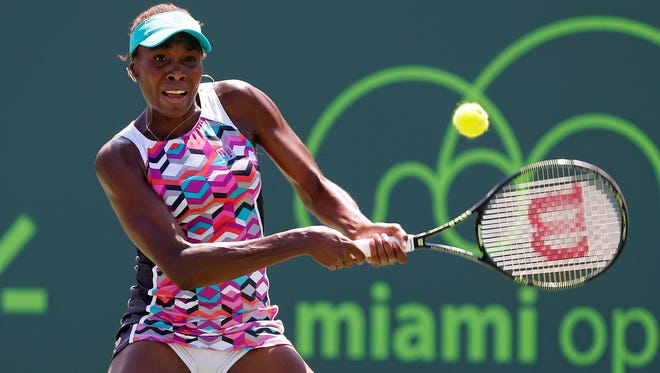 Venus Williams hits a backhand against Caroline Wozniacki on day eight of the Miami Open.