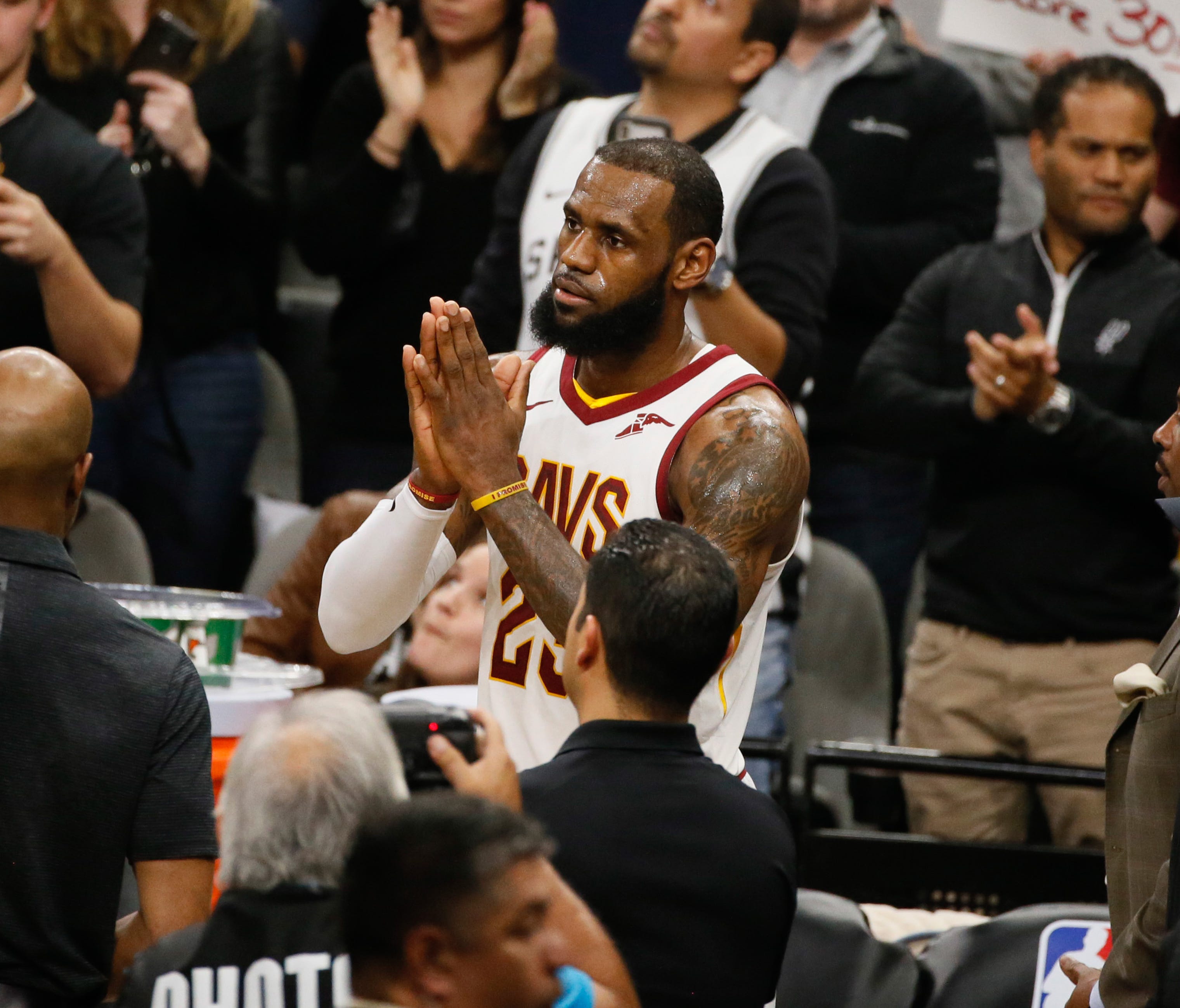 Cleveland Cavaliers small forward LeBron James celebrates after scoring his 30,000 career point during a time out against the San Antonio Spurs at AT&T Center.