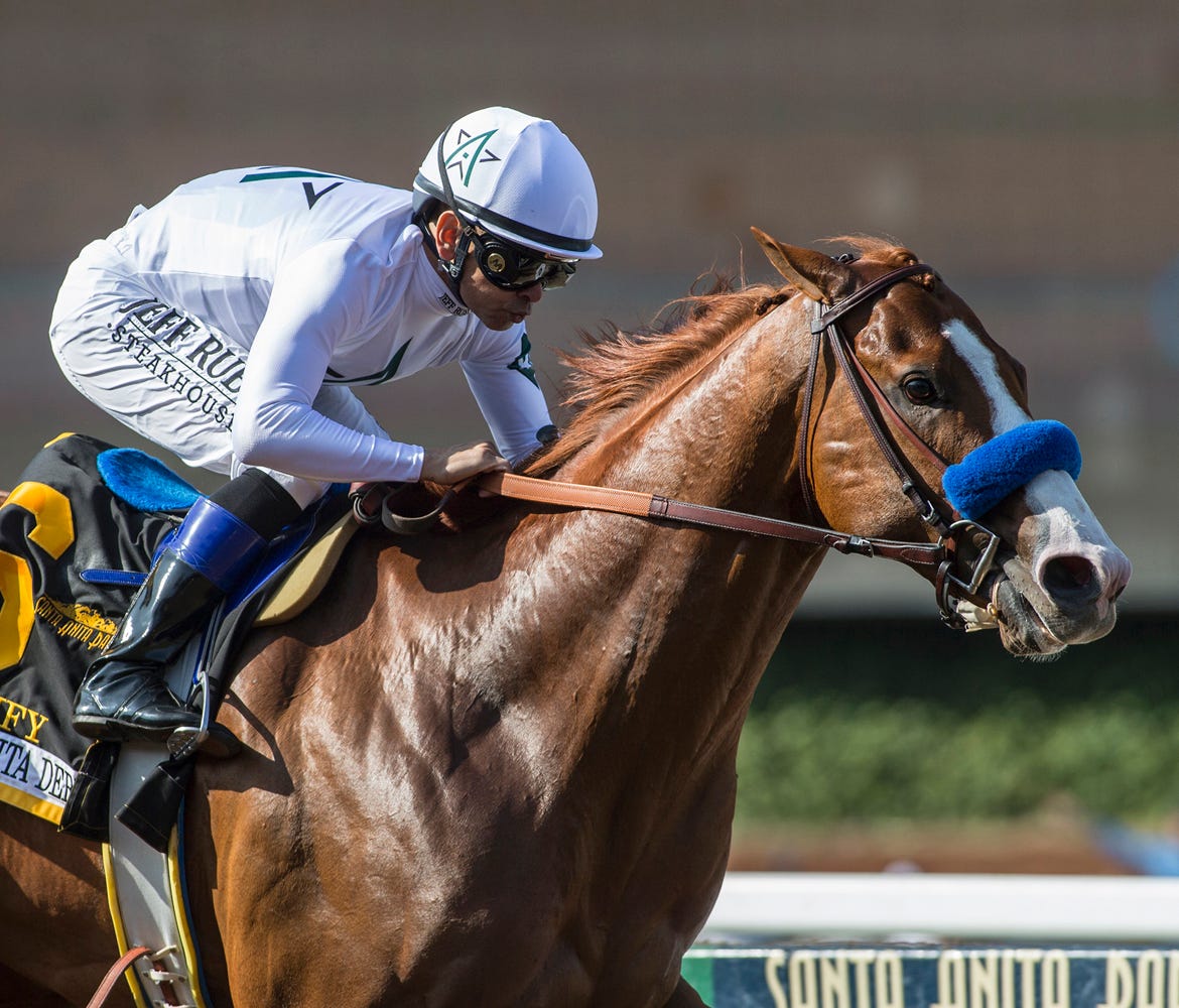 In a photo provided by Benoit Photo, Justify and Mike Smith win the Santa Anita Derby horse race Saturday, April 7, 2018, at Santa Anita in Arcadia, Calif.