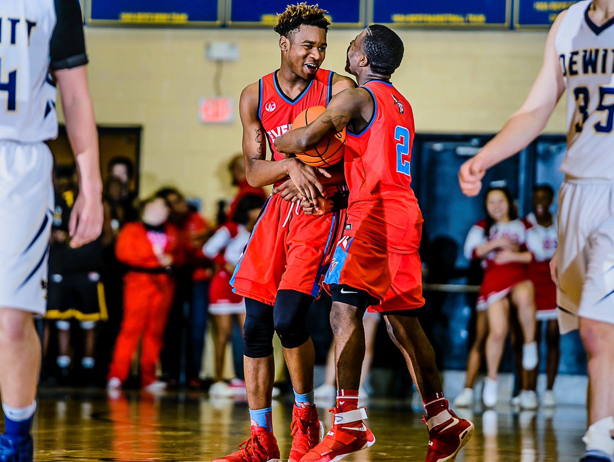 Marquez Gordon ,left, of Everett celebrates with teammate Nyreel Powell ,2, after Powell grabbed a rebound and was fouled with 9.6 seconds remaining in their Class A district semifinal game with DeWitt and Everett leading 49-47 Wednesday March 8, 2017 at Don Johnson Fieldhouse in Lansing.