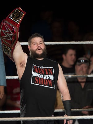 Kevin Owens holds up the WWE Universal Champion belt  during the WWE Raw Live performance at the Garrett Coliseum in Montgomery, Ala., on Saturday, Jan. 7, 2017. 