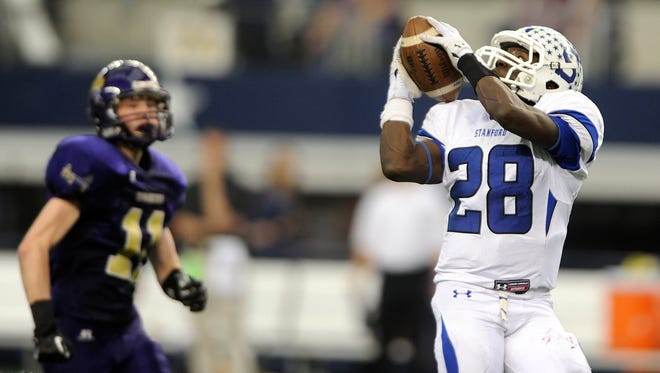 Stamford wide receiver James Washington (28) pulls in a 60-yard touchdown reception against Shiner in the fourth quarter of the Bulldogs' 41-28 win in the Class 1A Div. I state championship game in 2013 at AT&T Stadium in Arlington.