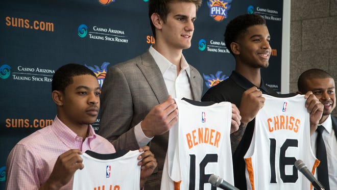 from left: Tyler Ulis, Dragan Bender and Marquese Chriss hold up Sun jerseys, June 24, 2016, during a press conference in the Van Arsdale Conference Room at Talking Stick Resort Arena, 201 E. Jefferson Street, Phoenix, Arizona. Looking on is Suns coach Earl Watson (right).
