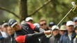 Tiger Woods hits from the fairway on the 1st hole during
