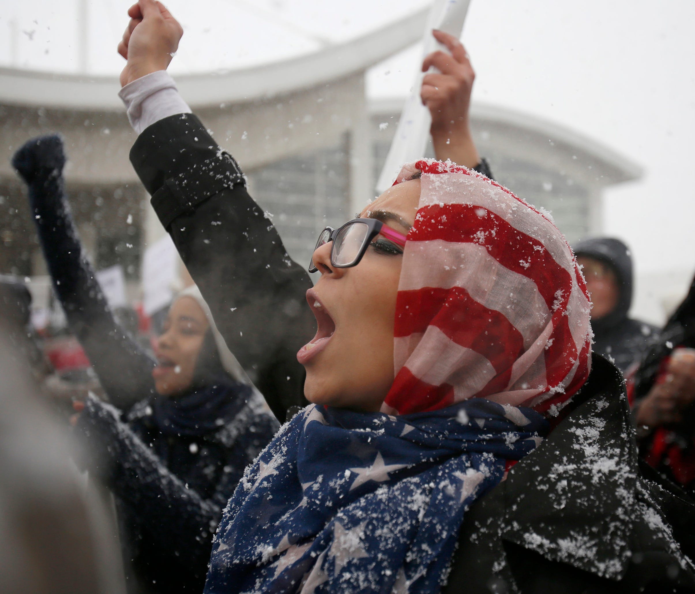 Khulud Fidama, 26, of Dearborn, Mich., stands with her family outside the McNamara Terminal at Detroit Metropolitan Airport to speak out against the recent executive order signed by President Trump on Jan. 29, 2017.