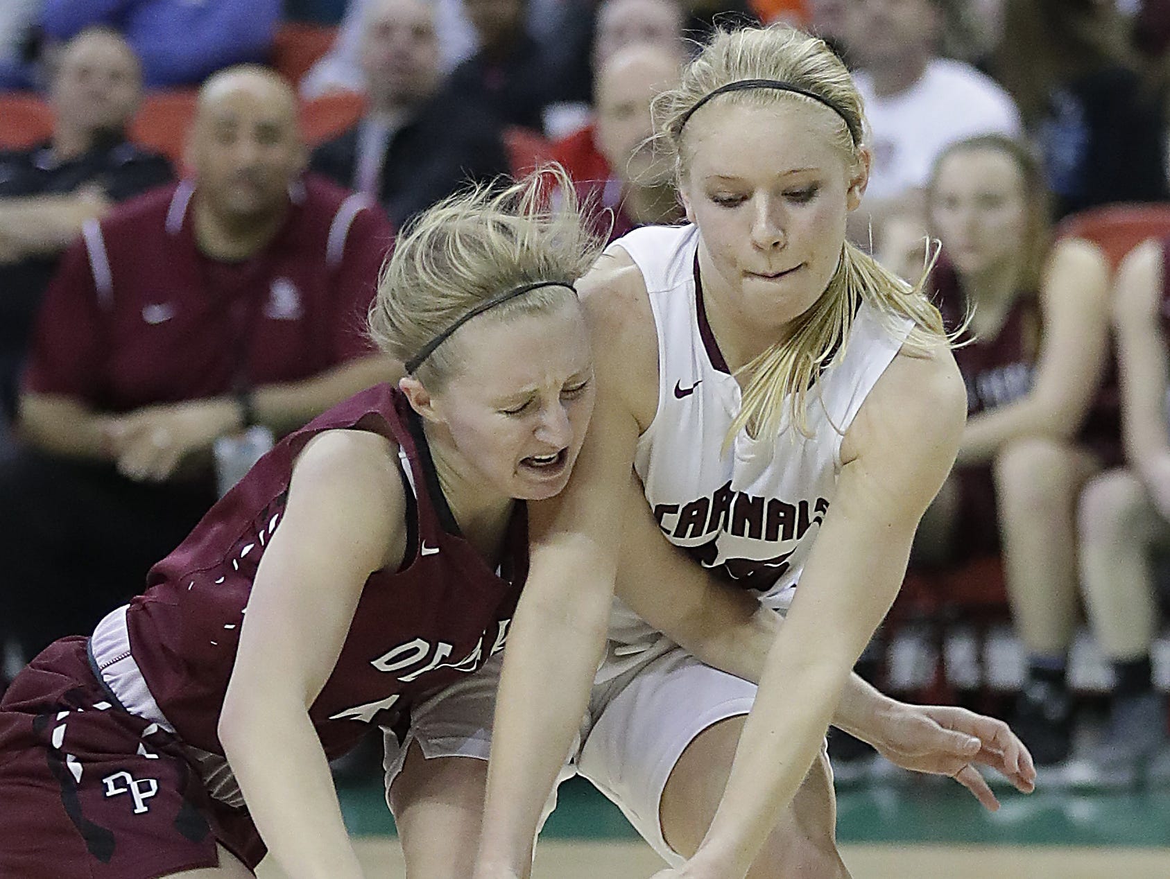 De Pere's Olivia DeCleene takes a hard foul during overtime against Middleton in the WIAA Division 1 Girls State Basketball semifinal at the Resch Center in Ashwaubenon Friday.