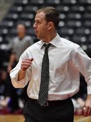 Prosper High School head basketball coach Jonathan Ellis yells from the sidelines during the team's regional semi-final game in 2019 against Midlothian High School at the Curtis Culwell Center in Garland.