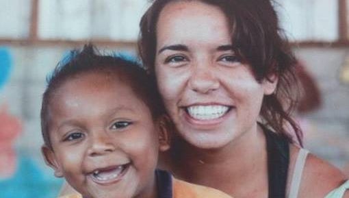 Taellor Stearns, right, a 2013 graduate of Ozark High School poses for an undated photograph with a child while serving on a religious mission to Nicaragua.