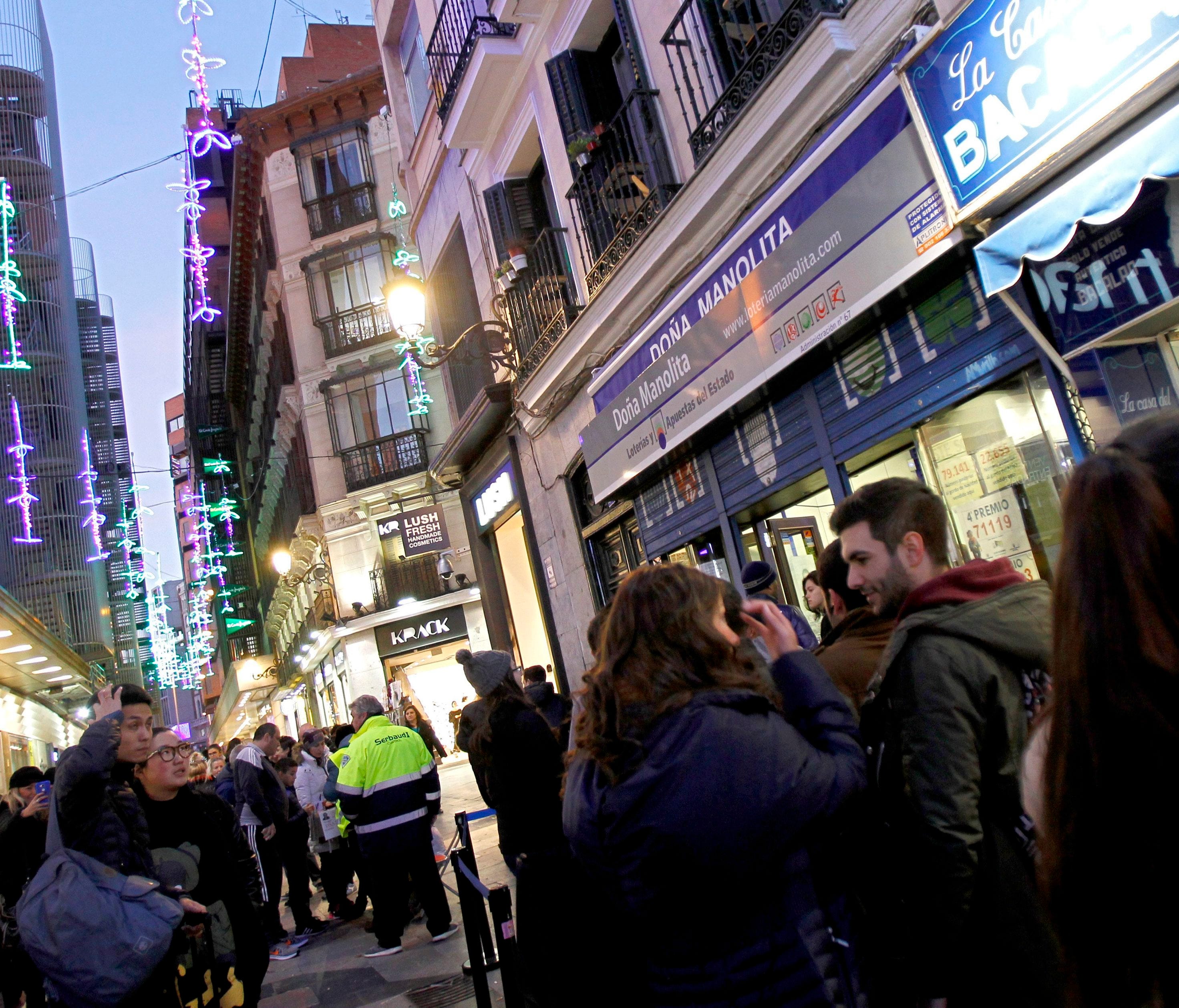 People line up at one of the most popular lottery shops (Dona Manolita) to buy tickets for El Gordo in Madrid, Spain, Dec. 19, 2016.