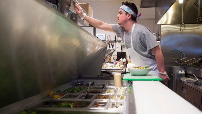 Line cook Ian Collicott works during dinner service at restaurant 415 Thursday, Feb. 25, 2016, in Fort Collins. Owners of the restaurant are challenging Larimer County's health inspection system after receiving ratings of 'inadequate' in each of the restaurant's last three full inspections.