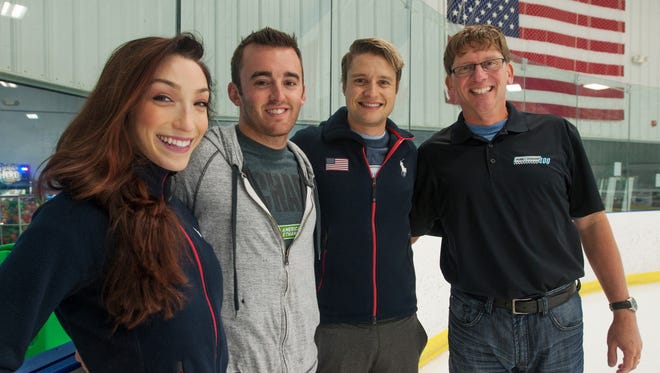 From left to right, ice dancer Meryl Davis, NASCAR driver Austin Dillon, ice dancer Charlie White and Michigan International Speedway president Roger Curtis skate at Arctic Edge Ice Arena, Thursday in Canton, Mich.