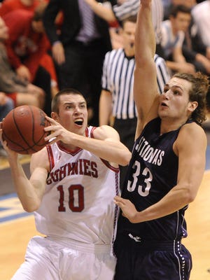 Joe Risinger drives against Conner Nord of St. Thomas during a game between the Johnnies and Tommies last season in Collegeville.