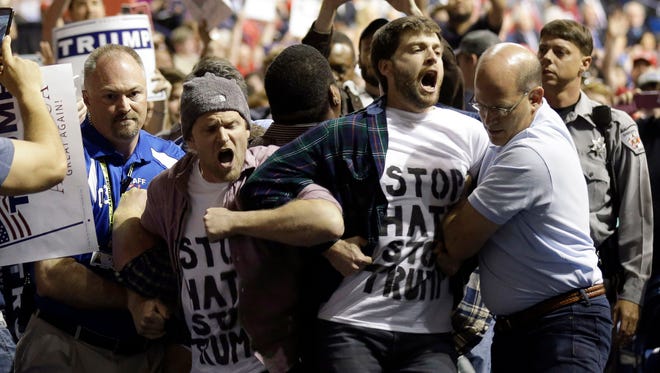 Protesters are removed as Donald Trump speaks during a campaign rally in Fayetteville, N.C., on March 9.