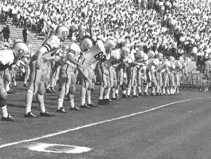Iowa football players stretch before the start of the