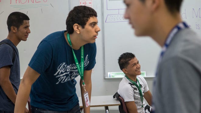 Candido Linares Garcia of Honduras (seated) attends Alhambra High School with several other migrant youths. This fall, the Phoenix Union High School
District has enrolled 88 students who traveled to the United States, many on their own, to escape violence in their home countries in Central America.