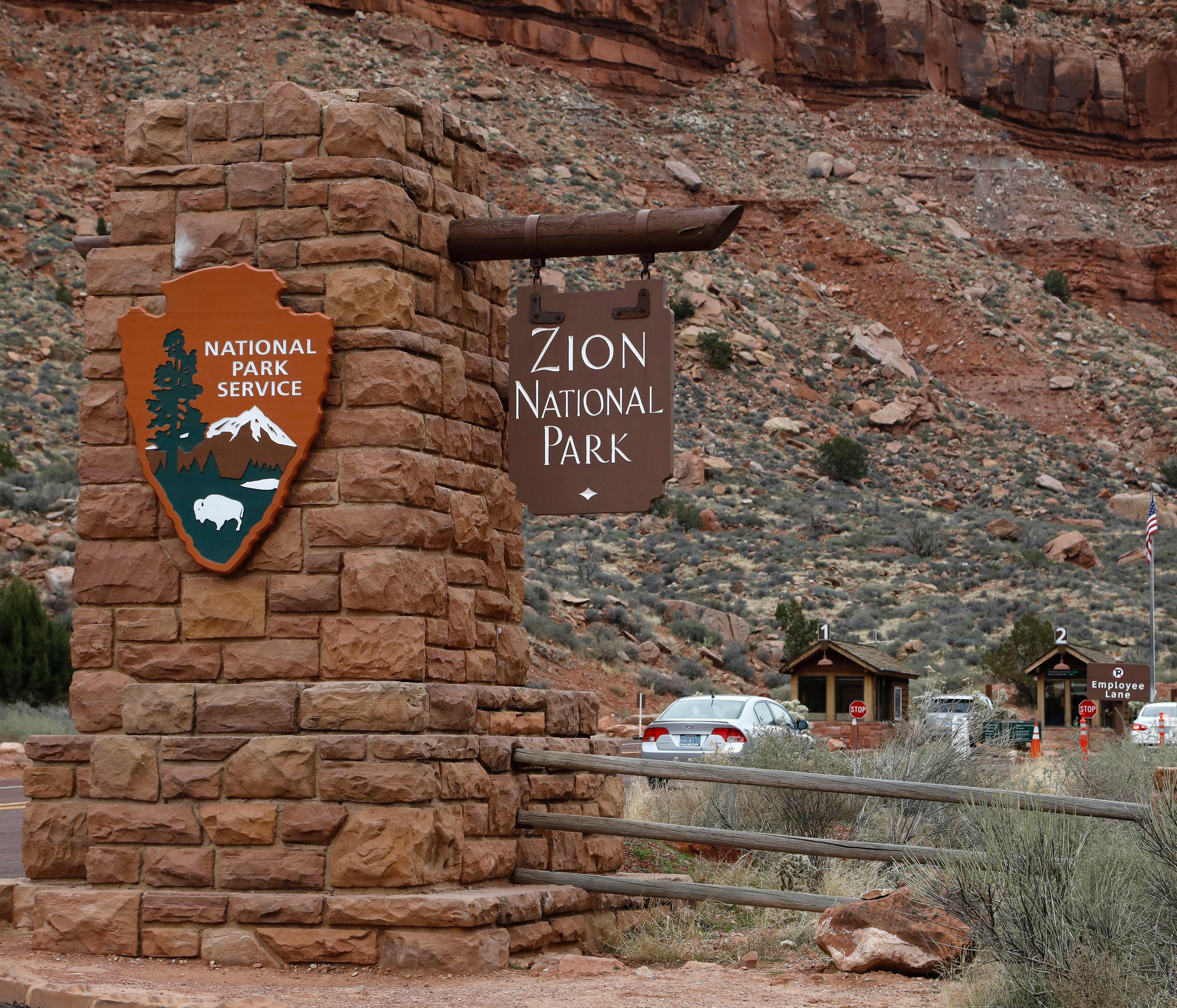 Cars drive through an entrance of Zion National Park, Utah, on February 9, 2017. / AFP PHOTO / RHONA WISE (Photo credit should read RHONA WISE/AFP/Getty Images) ORG XMIT: MIA132 [Via MerlinFTP Drop]