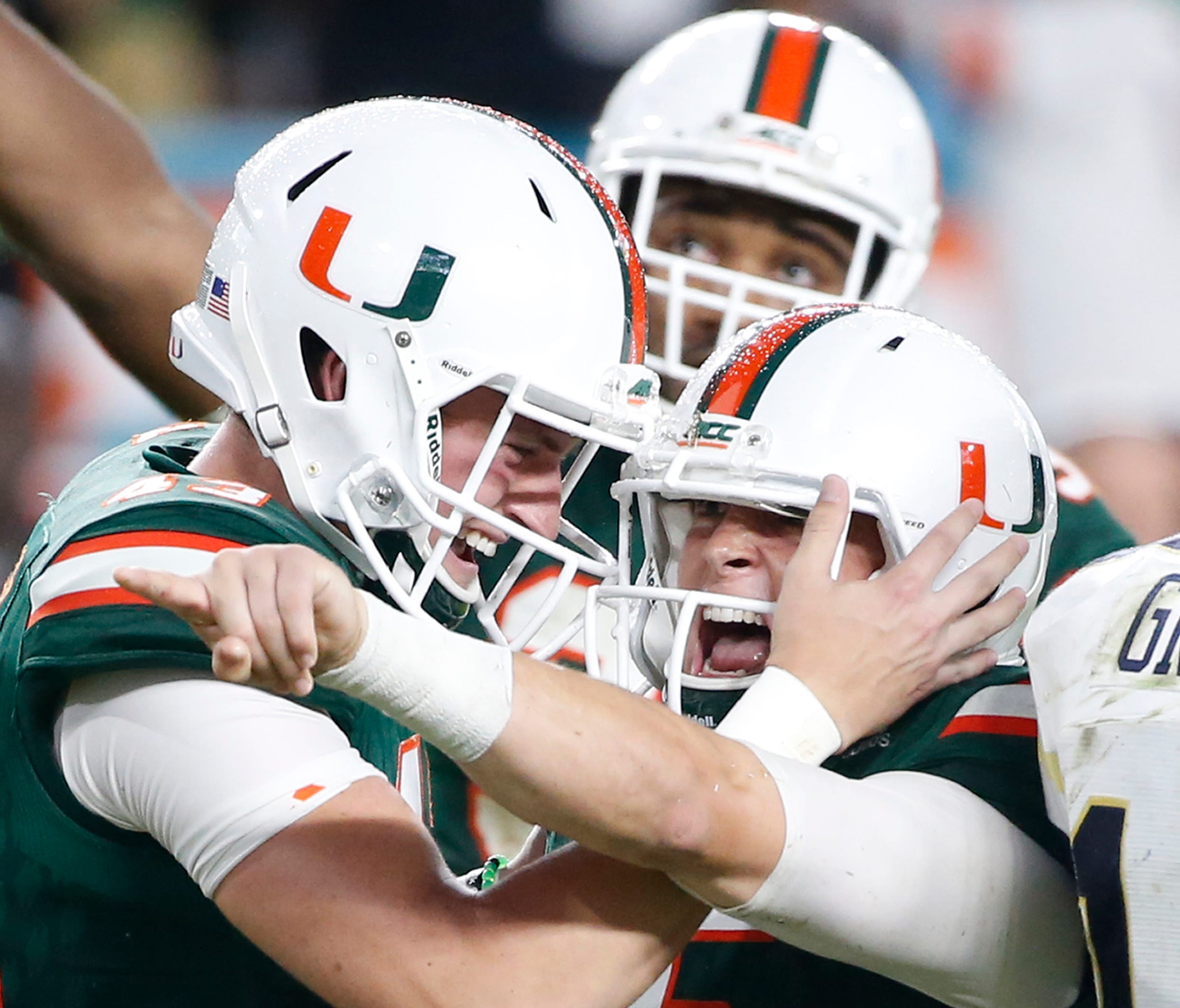Miami punter Jack Spicer, left, congratulates place kicker Michael Badgley after Badgley kicked a field goal with seconds remaining.