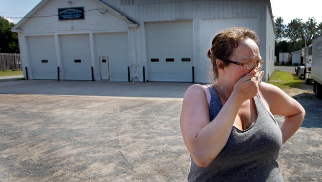 Lynn Hardy cries in front of the Westward Painting Co. Inc., where Kevin Ward Jr. worked on his car. Hardy was married to Kevin Sr.'s brother and says she still considers Kevin Jr. her nephew.