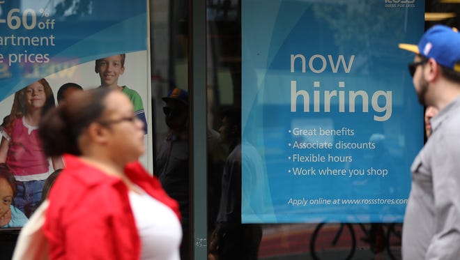A "now hiring" sign is posted outside a Ross Dress for Less store in  San Francisco.